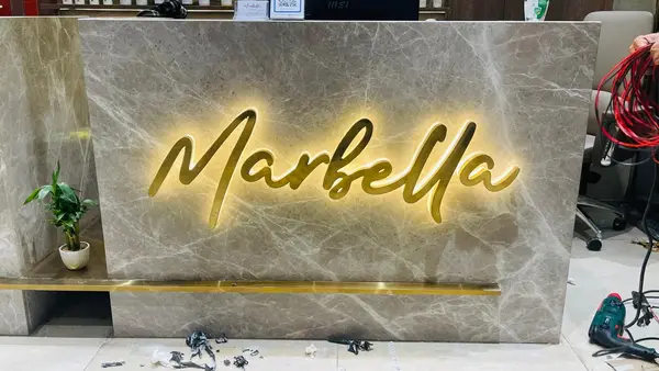 Marbella Salon reception wall branding by Brandmaxx